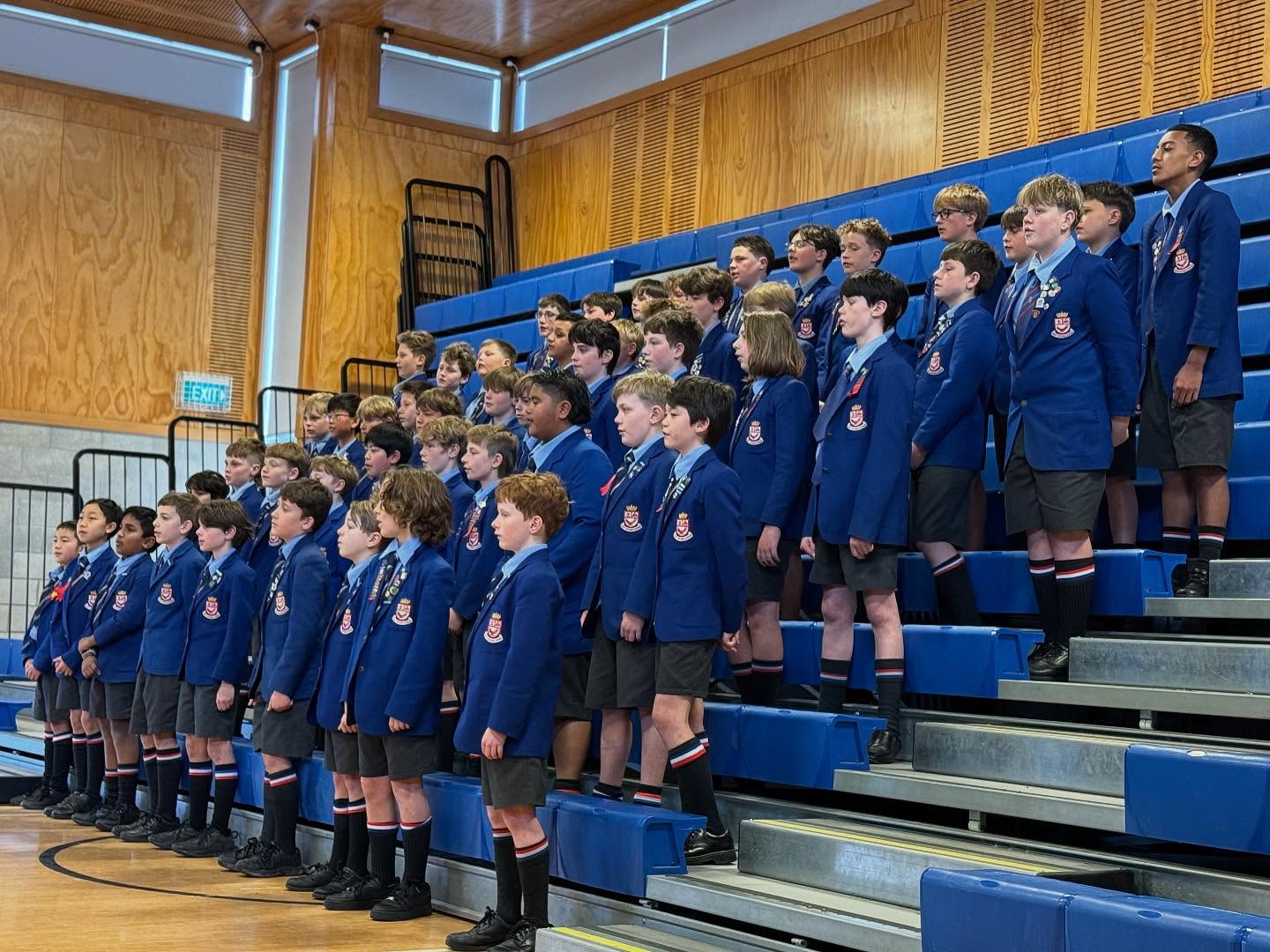 Wellesley College boys singing in the choir, standing in rows in their uniforms